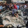 Local residents inspect a car that was destroyed by Israeli air strikes on July 9, 2026 in Gaza City, Gaza.
