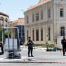 A cordoned-off area and a damaged structure in the aftermath of explosions near a hotel where French President Emmanuel Macron was meant to be staying, in Damascus, Syria, July 7, 2026. 