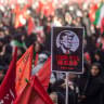 Mourners hold an anti-Trump poster as they gather during funeral ceremonies held for Iran's late Ayatollah Ali Khamenei on July 5, 2026 in Tehran, Iran.