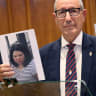 Monaco's Public Safety director Eric Arella holds up the red notice issued by Interpol against a Ukrainian woman suspected of planting a bomb in Monaco that injured three people, including a Ukrainian-born tycoon, during a press conference in Monaco on July 3, 2026.