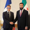 France's President Emmanuel Macron (L) shakes hands with Syrian President Ahmed al-Sharaa ahead of their meeting at the People's Palace in Damascus on July 7, 2026.
