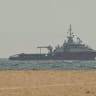 A ship sails off the coast of Ajman on July 10, 2026.