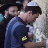 Lionel Messi, then with FC Barcelona, puts a paper with wishes in a crack in the Western Wall, Judaism's holiest site, in Jerusalem during a team trip to Israel and the West Bank, Aug. 4, 2013.