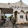  SYRIA-ISRAEL-CONFLICT-STRIKES A Syrian rebel soldier walks through the entrance of the port of Tartus in western Syria on December 16, 2024.