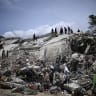 Firefighters and rescue workers operate amid the rubble of collapsed buildings following the June 24 earthquakes in Catia La Mar, La Guaira state, Venezuela on July 8, 2026.