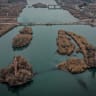 Illustrative: An aerial view shows people cross a damaged bridge over the Euphrates River as Syrian army forces deploy in parts of the eastern province formerly controlled by Kurdish forces following their withdrawal from the area on January 22, 2026 in Deir al-Zor, Syria.