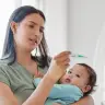 A mother measures her baby's temperature