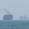 This frame grab taken from AFPTV video footage on July 12, 2026 shows cargo ships anchoring near the Strait of Hormuz off the eastern coast of the United Arab Emirates at Khor Fakkan.