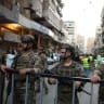 Members of the Lebanese army secure the area near the site of an Israeli strike, in Beirut's southern suburbs, Lebanon November 23, 2025