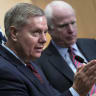 US Sen. Lindsey Graham (L) speaks near US Republican Sen. John McCain during a news conference at the David Citadel hotel in Jerusalem January 3, 2014.