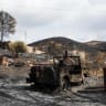 A burned vehicle in a burned area following deadly wildfires in Almocaizar, Almeria, Spain, July 12, 2026.