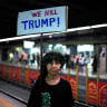 A child poses for a picture holding an anti US president Donald Trump placard as mourners gather ahead of the funeral procession of Iran's slain supreme leader Ali Khamenei , in Mashhad on July 9, 2026. 