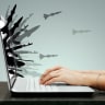 An illustrative image of weapons and ordinance coming out of a laptop screen.