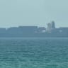 This frame grab taken from AFPTV video footage on July 12, 2026 shows a cargo ship anchoring near the Strait of Hormuz off the eastern coast of the United Arab Emirates at Khor Fakkan.