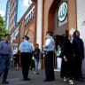 Police liaison officers stand guard outside the East London Mosque in Tower Hamlets, London on August 9, 2024. 