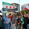 People wave Syrian and Lebanese flags during a visit by the Syrian foreign minister in Lebanon's northern city of Tripoli on July 2, 2026.