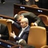 Prime Minister Benjamin Netanyahu and Communications Minister Shlomo Karhi are seen in the Knesset plenum during a vote on the minister's communications reform, in Jerusalem, July 16, 2026