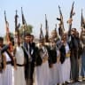 Armed Yemenis brandish their weapons as they rally in solidarity with Lebanon and Iran on the outskirts of the Huthi-controlled capital Sanaa on July 2, 2026. 