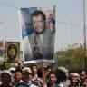 A person holds a poster of Houthi leader, Abdul-Malik al-Houthi, amid protests at the Sana'a University campus in support of the Houthi movement, in Sana'a, Yemen, July 15, 2026