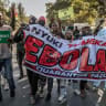 Protesters hold a banner and chant slogans as they march during a demonstration against a controversial US-built Ebola quarantine centre slated to begin operations at Laikipia Air Base in Nanyuki on June 9, 2026. 