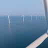Expansive view of offshore wind turbines. Ilustrative.