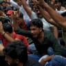 Demonstrators shout slogans at a protest site ahead of a planned march by supporters of India's Cockroach Janta Party towards parliament on the opening day of its monsoon session, demanding the resignation of Education Minister Dharmendra Pradhan over exam paper leaks near Jantar Mantar, New Delhi.