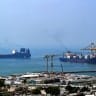 Ships are docked along a pier at the Khor Fakkan Container Terminal, the only natural deep-sea port in the region and one of the major container ports in Sharjah Emirate, along the Gulf of Oman on July 14, 2026.