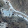 A satellite view shows vehicles at an entrance to Pickaxe Mountain tunnels, of the of the Natanz nuclear facility, near Natanz, Iran, June 21, 2026.