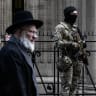 Belgian military personnel armed with assault rifles stand guard outside a synagogue in central Antwerp as part of Belgium’s reinforced security measures established at Jewish schools and synagogues, on March 23.