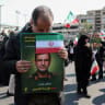 People hold portraits of Alireza Tangsiri, commander of the Iranian Revolutionary Guards' navy, during his funeral in Tehran, April 1, 2026