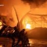 Firefighters work at the site of a household item shopping mall which was hit by a Russian drone strike, amid Russia's attack on Ukraine, in Sumy, Ukraine in this handout picture released July 21, 2026.