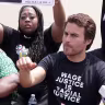 Kai Newkirk participates in civil disobedience to stop traffic during a “Freedom Friday March” protest at Ronald Reagan Washington National Airport, Aug. 6, 2021, Arlington, Virginia. 