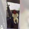 An infant is seen propped up on a sofa next to an M16 rifle, in a series of incriminating photos obtained by Israel Police.
