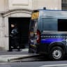 A private security member stands next to a police van. Ilustrative.