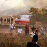 Israeli soldiers disperse with tear gas Palestinians who had gathered as a fire blazes near the village of Tell, adjacent to the Israeli settlement of Havat Gilad, west of Nablus in the West Bank on July 18, 2026.