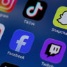 Instagram, TikTok, Snapchat, YouTube, Facebook, Twitch and Reddit applications are displayed on a mobile phone in this picture illustration.