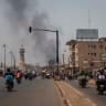 A column of black smoke rises above buildings as traffic passes the Africa Tower monument in Bamako on April 26, 2026; Illustrative.