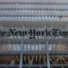 The New York Times logo is seen on the building's facade in New York City on January 22, 2026. US President Donald Trump announced today he will sue The New York Times over an unfavorable opinion poll and suggested that what he called "fake" surveys should criminalized.