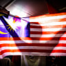 A supporter of Malaysia's opposition leader Anwar Ibrahim, chairman of the Pakatan Harapan (The Alliance of Hope) coalition, holds a Malaysia flag during an election campaign rally on November 16, 2022; file photo.