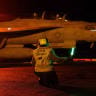 U.S. Sailors signal an F/A-18E Super Hornet on the deck of USS George H.W. Bush (CVN 77) as the aircraft carrier transits the Arabian Sea.