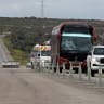 Illustrative: A bus transporting supporters of the government is escorted as it makes its way during an exchange of prisoners' ceremony between Syrian authorities and Druze fighters, on the outskirts of Sweida, southern Syria on February 26, 2026. 