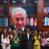 Brazilian Senator Flavio Bolsonaro, who is to be announced as candidate for Brazil's presidential elections, stands in front of a screen showing a pre-recorded message from Israeli Prime Minister Benjamin Netanyahu during the national convention of the Liberal Party (PL) in Brazil, July 25, 2026.