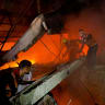 Civil Defense personnel respond following an Israeli strike on a residential apartment in Gaza City, July 21, 2026. Picture taken with a mobile phone. 