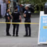 Police officers gather at a site after Seattle Police responded to what they described as a shooting with "multiple" victims at Seattle Center, which was hosting a Bite of Seattle food festival, in Seattle, Washington, US, July 26, 2026. 
