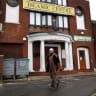 A man walks past an Islamic Centre in Luton, southern England December 13, 2010. 