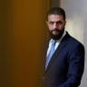Syrian President Ahmed al-Sharaa listens to French President during a joint press conference after a meeting at the Elysee Palace in Paris, on May 7, 2025.
