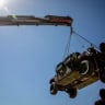 A crane hoists a tactical vehicle at the Logistics Support Area, in a location given as near Kerem Shalom, in this handout picture released June 30, 2026, by the Trump-appointed Board of Peace.