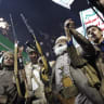  Protesters who support Yemen's Houthi group brandish weapons and shout slogans as they celebrate the ban decision imposed against the maritime shipping of Saudi Arabia on July 20, 2026 in Sana'a, Yemen. 