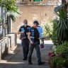 Police officers stand at the scene of last night’s murder of a 19-year-old man in the Nachlaot neighborhood of Jerusalem, July 12, 2026.