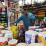 A shopkeeper speaks on the phone as he sells rice and grains inside a wholesale market in Kolkata, India, January 13, 2026.